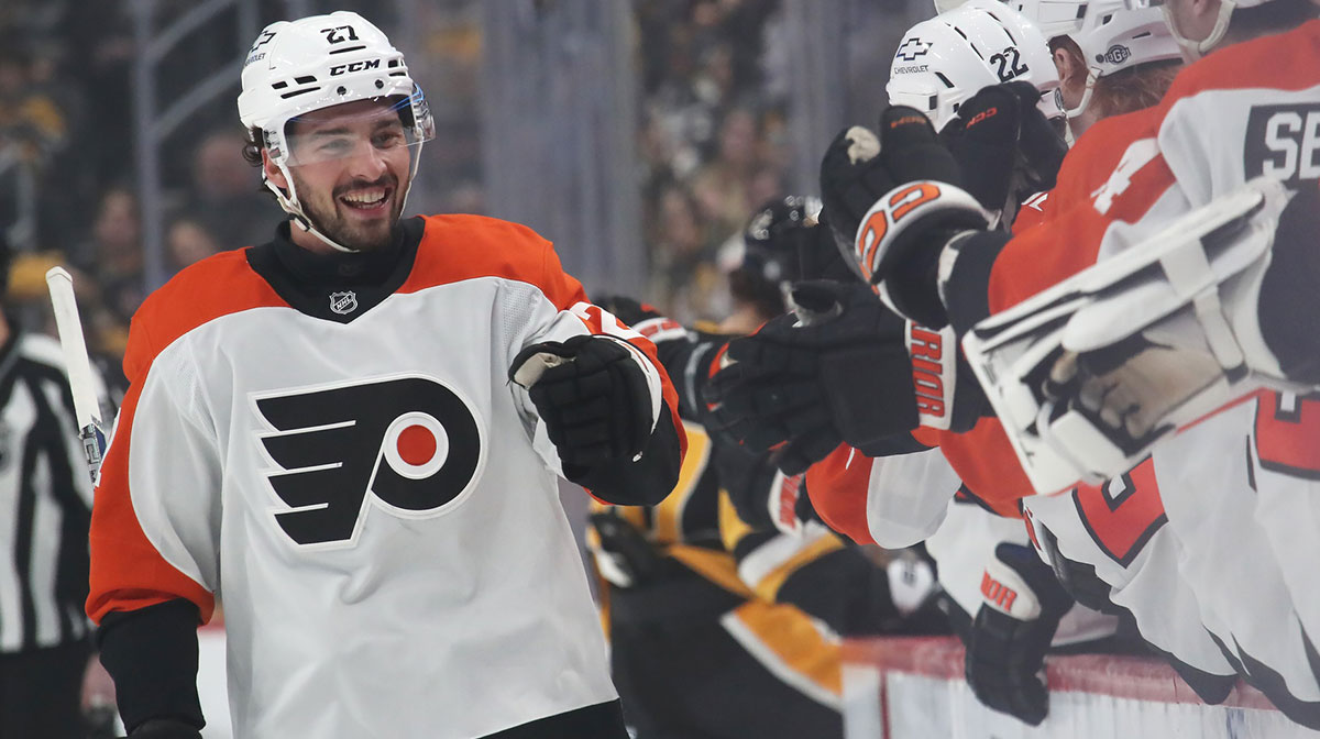 Philadelphia Flyers left wing Noah Cates (27) celebrates with the Flyers bench after scoring a goal against the Pittsburgh Penguins during the first period at PPG Paints Arena.