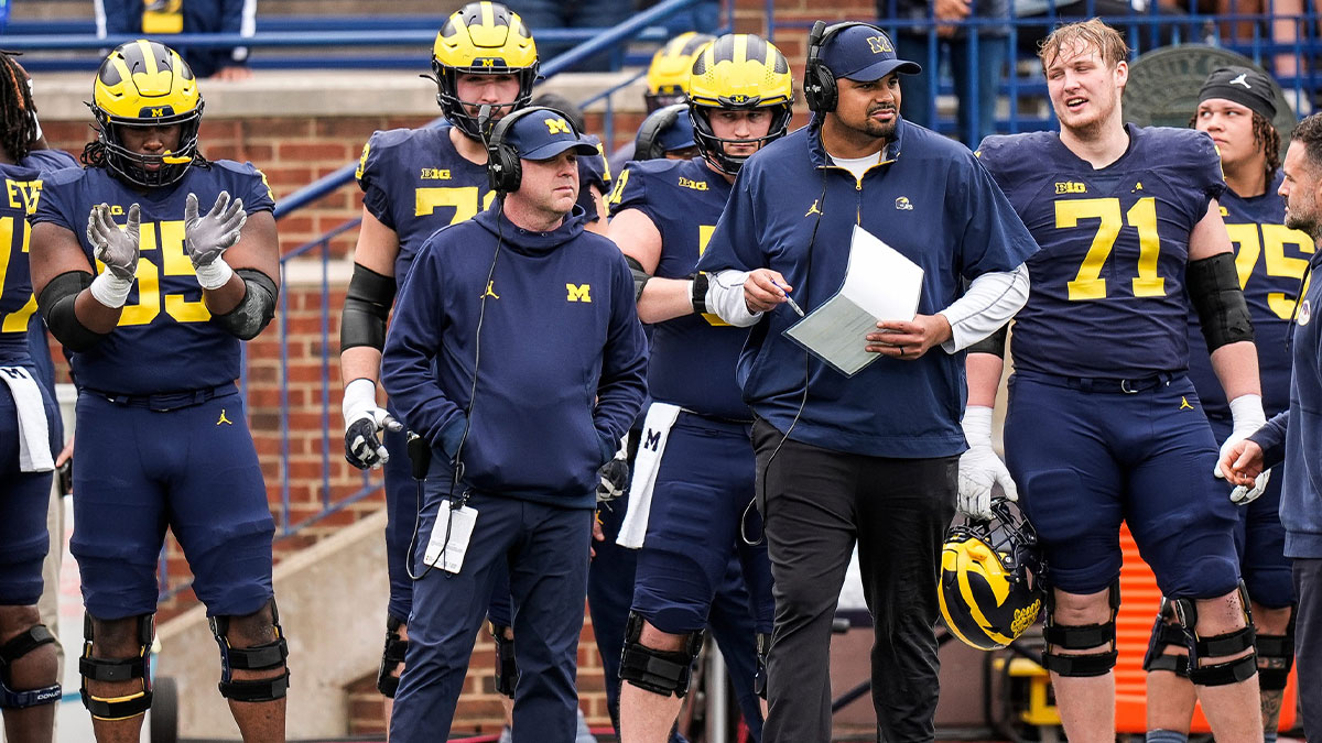 Michigan offensive coordinator Chip Lindsey, left, and offensive line coach Grant Newsome watch warm up before the spring game at Michigan Stadium