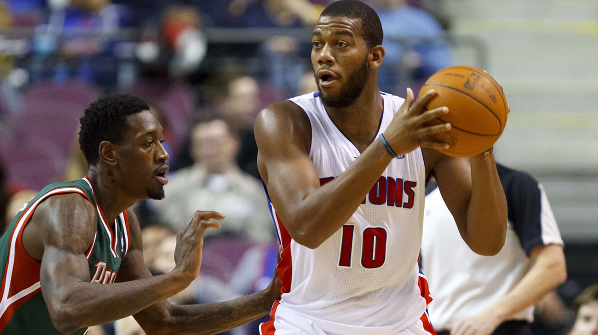 Detroit Pistons center Greg Monroe (10) is defended by Milwaukee Bucks point guard Brandon Jennings (3) at The Palace.