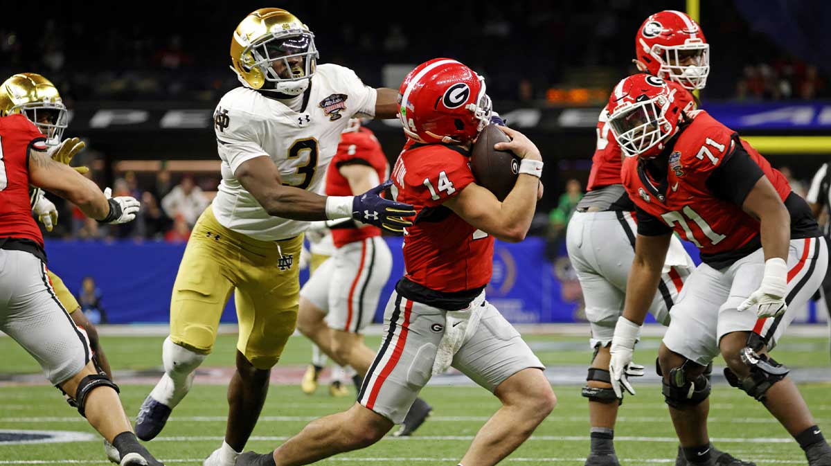 Georgia Bulldogs quarterback Gunner Stockton (14) runs with the ball during the second half against Notre Dame Fighting Irish running back Gi'Bran Payne (3) at Caesars Superdome.