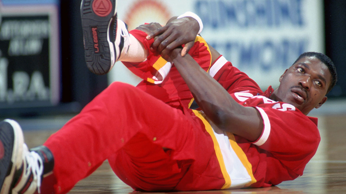 Houston Rockets center #34 HAKEEM OLAJUWON stretches before his game against the Orlando Magic at the Orlando Arena.
