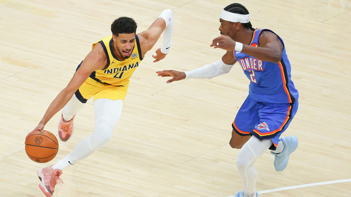Indiana Pacers guard Tyrese Haliburton (0) drives to the basket against Oklahoma City Thunder guard Shai Gilgeous-Alexander (2) in the first quarter during game six of the 2025 NBA Finals at Gainbridge Fieldhouse.