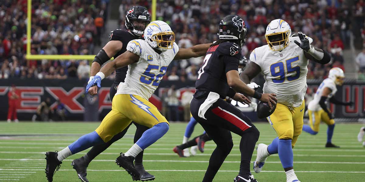 Houston Texans quarterback C.J. Stroud (7) is defended by Los Angeles Chargers defensive lineman Poona Ford (95) and outside linebacker Khalil Mack (52) in the second quarter in an AFC wild card game at NRG Stadium.