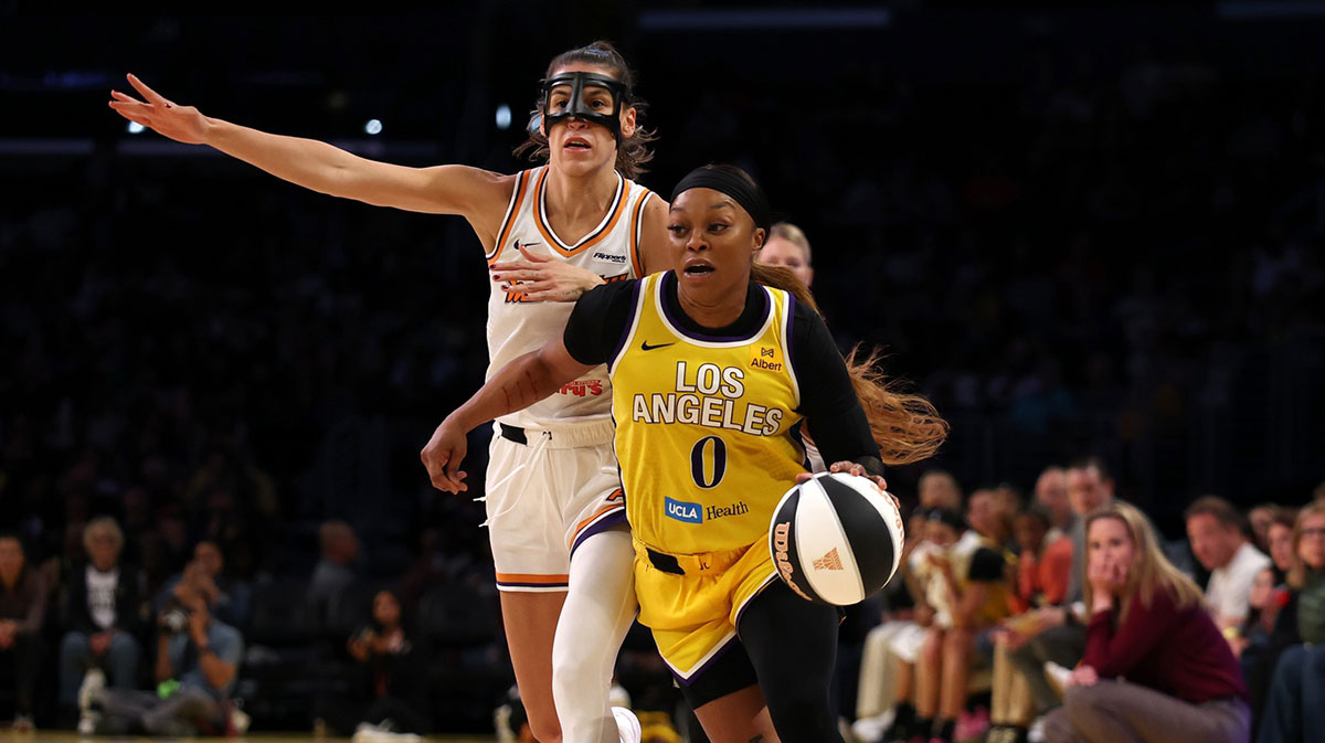 ; Los Angeles Sparks guard Odyssey Sims (0) dribbles the ball ahead of Phoenix Mercury guard Sevgi Uzun (10) during the third quarter at Crypto.com Arena.
