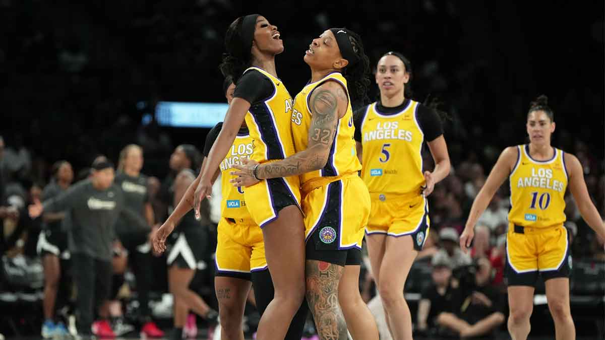 Los Angeles Sparks forwards Emma Cannon (32) and Rickea Jackson (2) celebrate after scoring against the Las Vegas Aces during the first half of a WNBA basketball game at Michelob Ultra Arena.