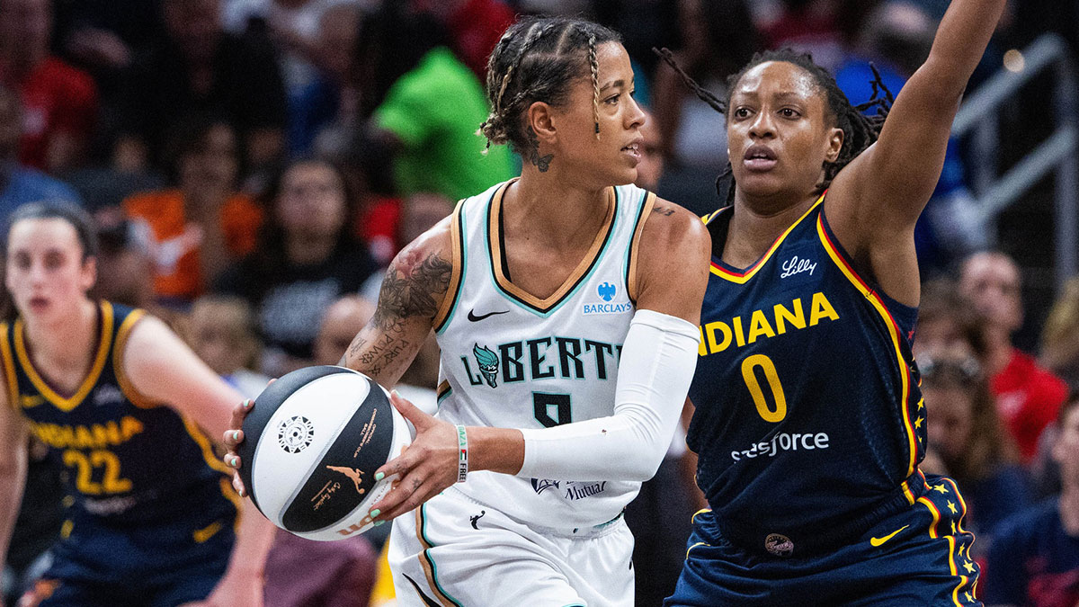 New York Liberty guard Natasha Cloud (9) holds the ball while Indiana Fever guard Kelsey Mitchell (0) defends in the first half at Gainbridge Fieldhouse.