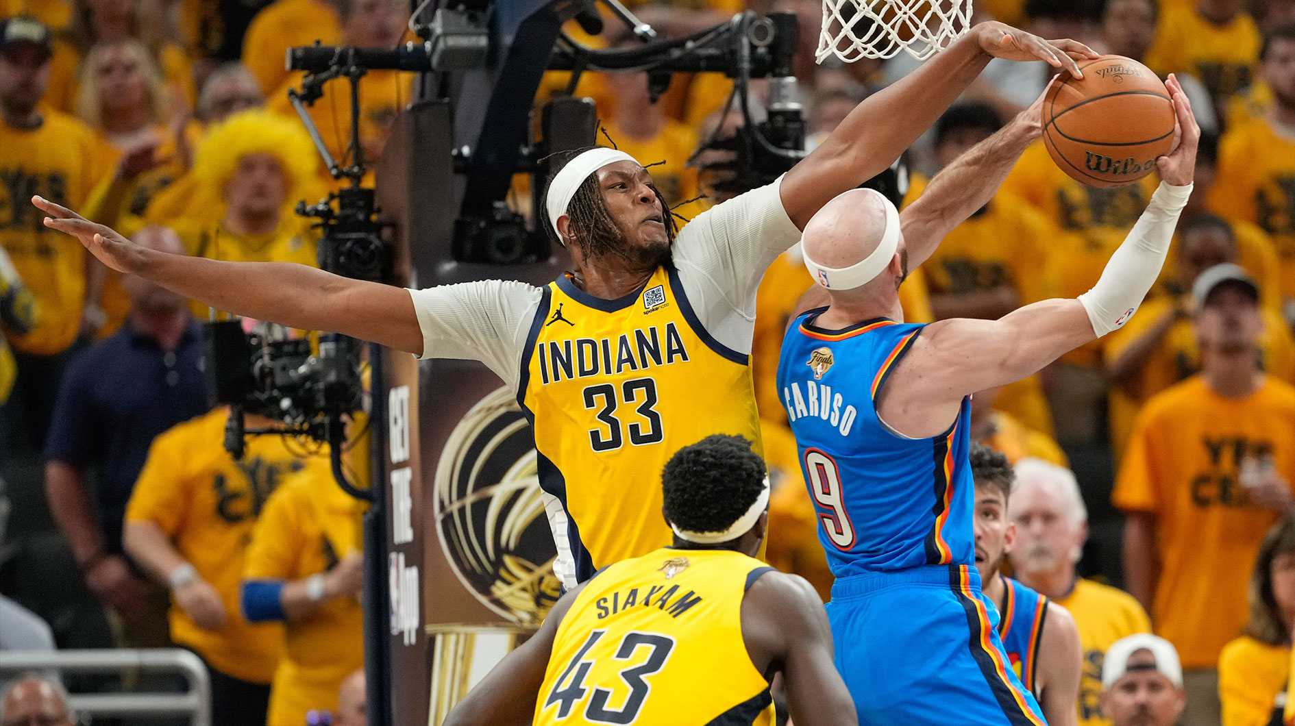 Indiana Pacers center Myles Turner (33) blocks a shot by Oklahoma City Thunder guard Alex Caruso (9) in the third quarter during game six of the 2025 NBA Finals at Gainbridge Fieldhouse.