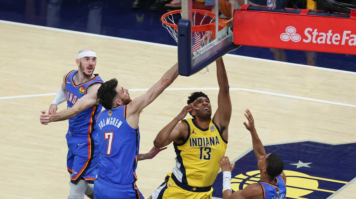 Indiana Pacers center Tony Bradley (13) shoots the ball against Oklahoma City Thunder guard Alex Caruso (9), forward Chet Holmgren (7) and guard Aaron Wiggins (21) in the second quarter during game six of the 2025 NBA Finals at Gainbridge Fieldhouse.