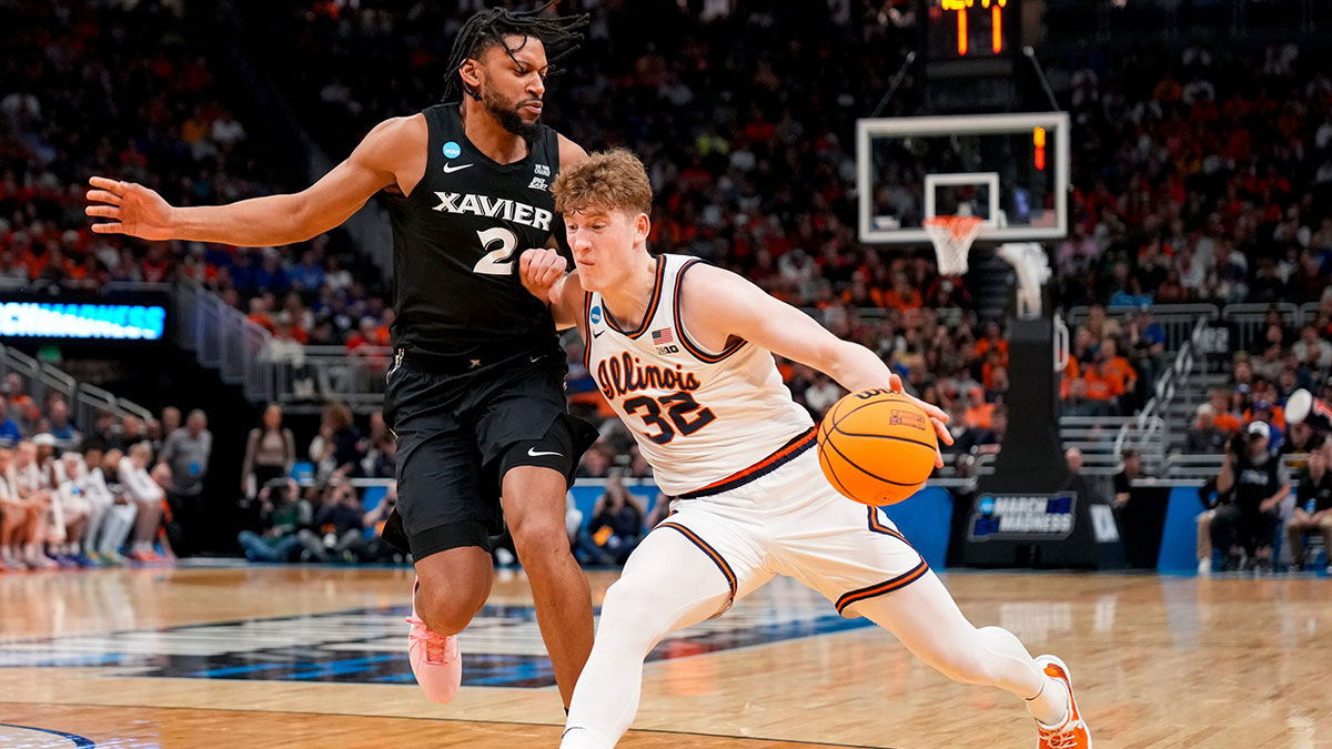 Illinois Fighting Illini guard Kasparas Jakucionis (32) drives against Xavier Musketeers forward Jerome Hunter (2) in the first half of the NCAA Tournament First Round game between the Illinois Fighting Illini and the Xavier Musketeers at Fiserv Forum in Milwaukee on Friday, March 21, 2025. Xavier was eliminated from the tournament, losing 86-73, to Illinois.