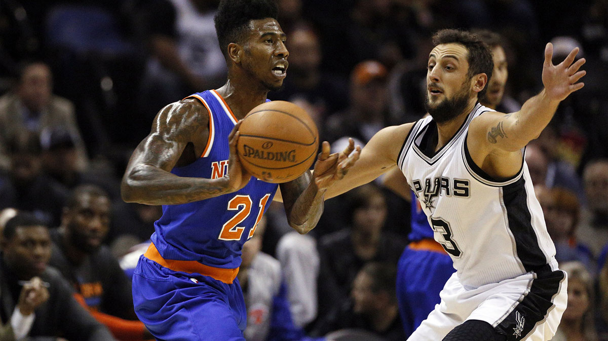 New York Knicks shooting guard Iman Shumpert (21) looks to pass as San Antonio Spurs shooting guard Marco Belinelli (3) defends during the first half at AT&T Center.