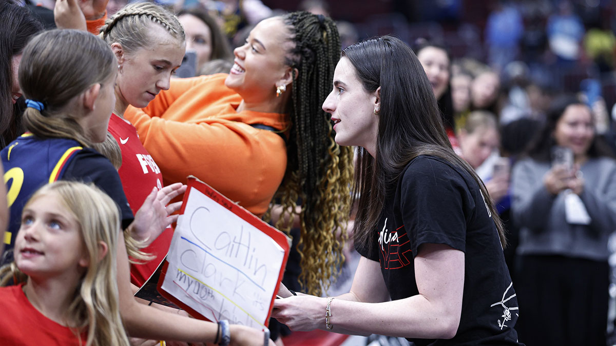 Indiana Fever guard Caitlin Clark (22) signs autographs before a WNBA game against the Chicago Sky at United Center.