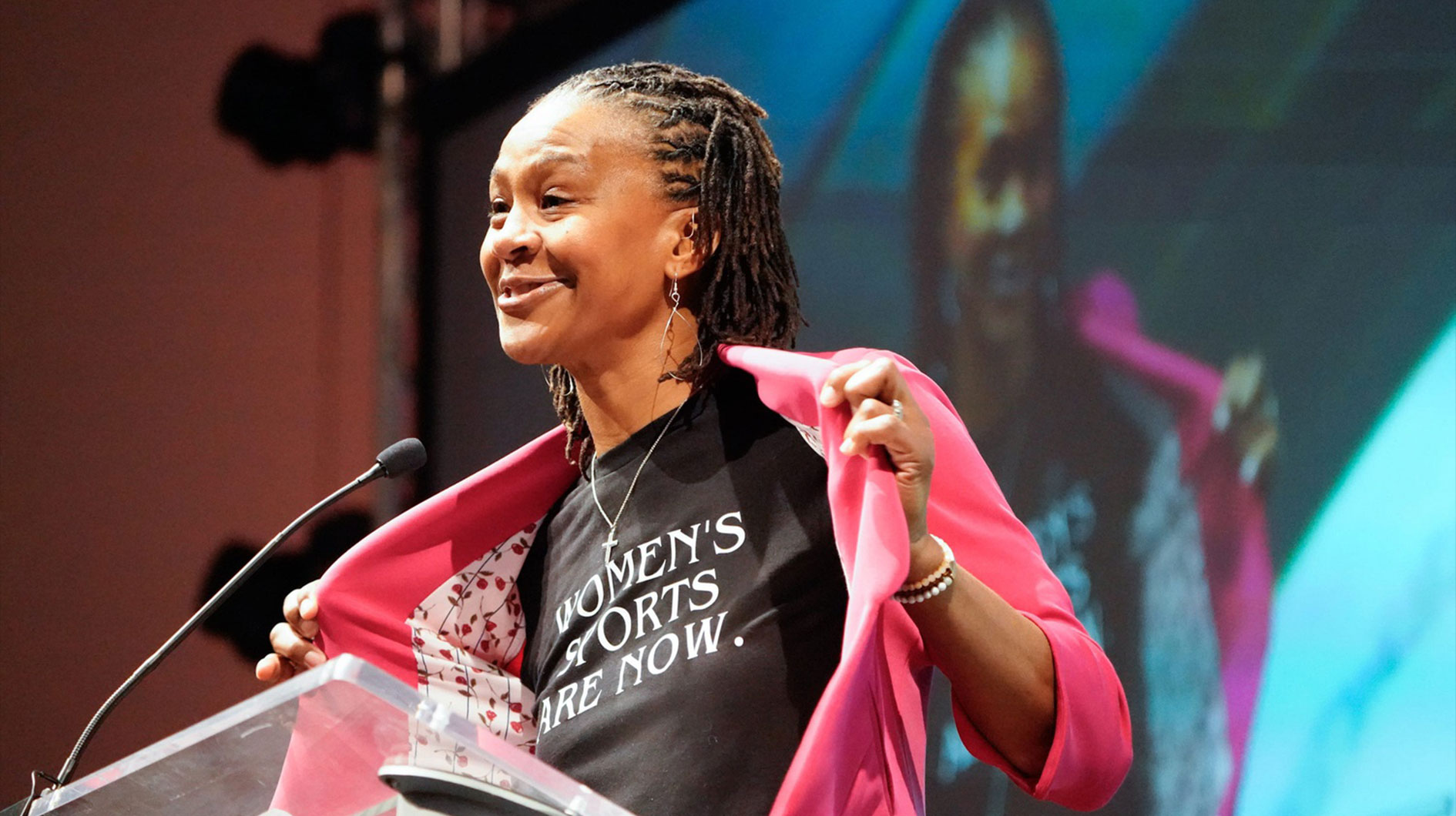 Retired Indiana Fever player Tamika Catchings shows off her shirt for national Girls and Women in Sport Day during the annual Indiana State of Tourism event held at the Indiana Convention Center on Wednesday, Feb. 5, 2025, in Indianapolis.