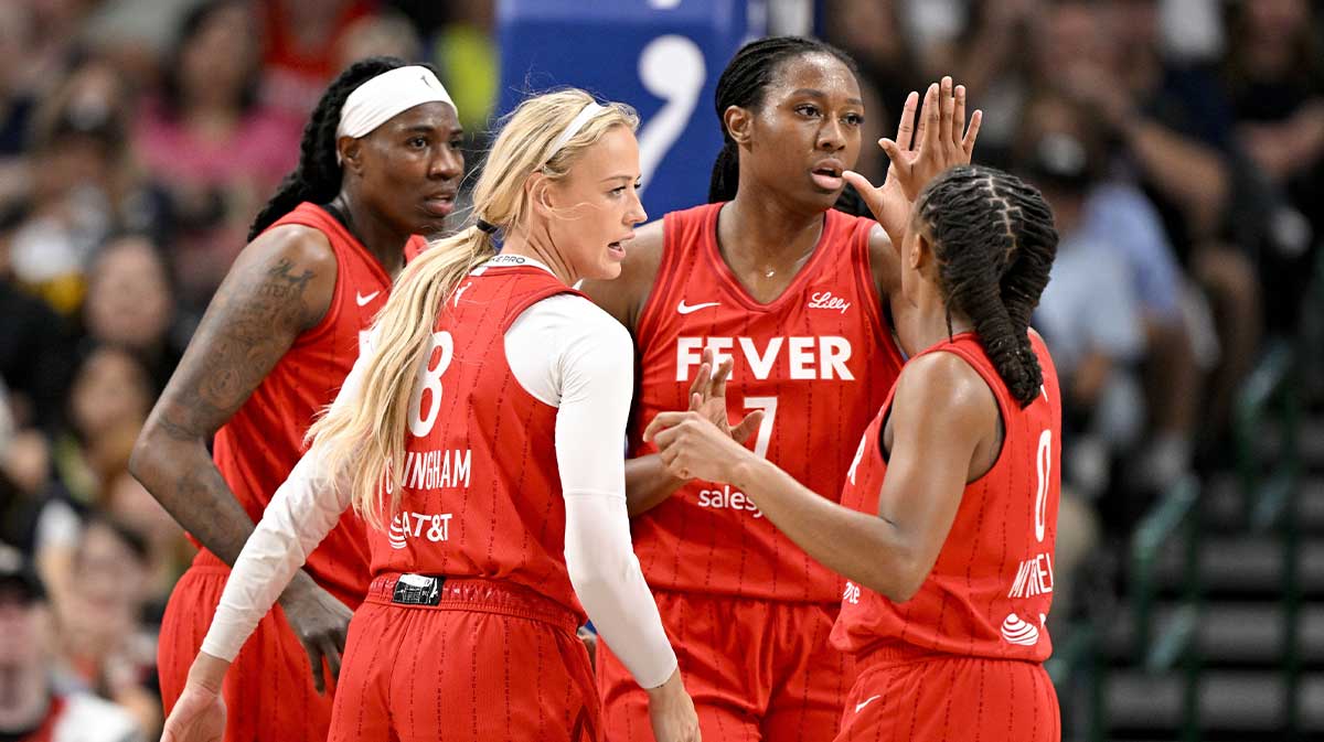 Indiana Fever guard Sophie Cunningham (8) and forward Aliyah Boston (7) and guard Kelsey Mitchell (0) celebrate during the first quarter against the Dallas Wings at the American Airlines Center.