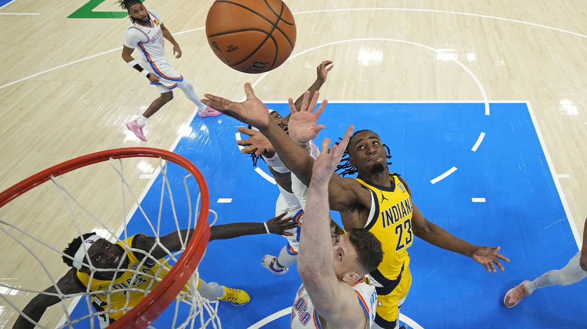 Indiana Pacers forward Aaron Nesmith (23) reaches for the ball against Oklahoma City Thunder center Isaiah Hartenstein (55) during the first quarter in game one of the 2025 NBA Finals at Paycom Center.