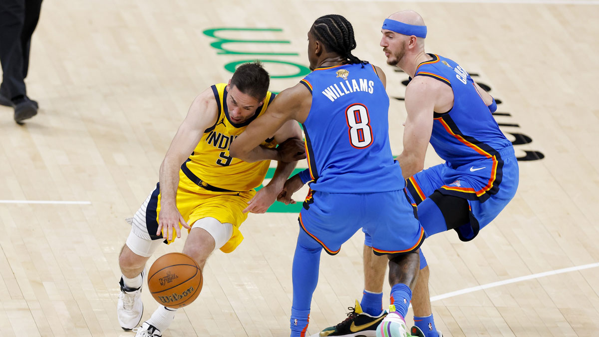 Indiana Pacers guard T.J. McConnell (9) drives to the basket past Oklahoma City Thunder forward Jalen Williams (8) and guard Alex Caruso (9) during the fourth quarter of game two of the 2025 NBA Finals at Paycom Center.