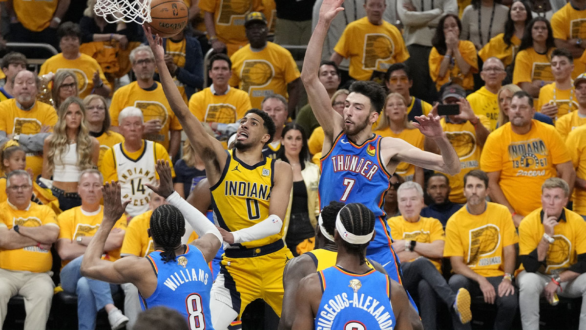 Indiana Pacers guard Tyrese Haliburton (0) drives to the hoop past Oklahoma City Thunder forward Jalen Williams (8), guard Shai Gilgeous-Alexander (2) and forward Chet Holmgren (7) during the third quarter of game four of the 2025 NBA Finals at Gainbridge Fieldhouse.