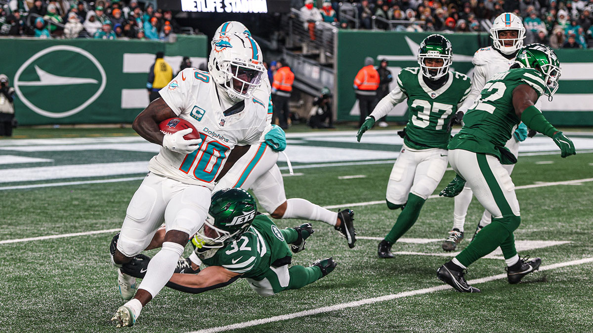 Miami Dolphins wide receiver Tyreek Hill (10) is tackled by New York Jets running back Isaiah Davis (32) during a punt return during the first half at MetLife Stadium.