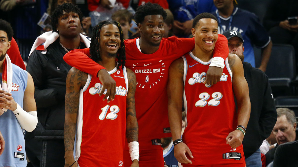 Memphis Grizzlies guard Ja Morant (left), forward Jaren Jackson Jr. (middle) and guard Desmond Bane (right) react during the fourth quarter against the Golden State Warriors at FedExForum.