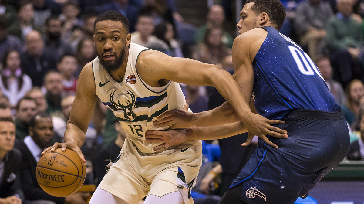 Milwaukee Bucks forward Jabari Parker (12) drives for the basket as Orlando Magic forward Aaron Gordon (00) defends during the third quarter at BMO Harris Bradley Center.