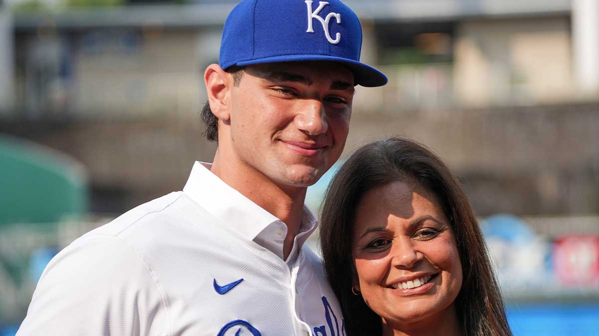 Kansas City Royals first round draft pick Jac Caglianone poses with his mother Johanne Caglianone for photos on the field prior to a game against the Arizona Diamondbacks at Kauffman Stadium.