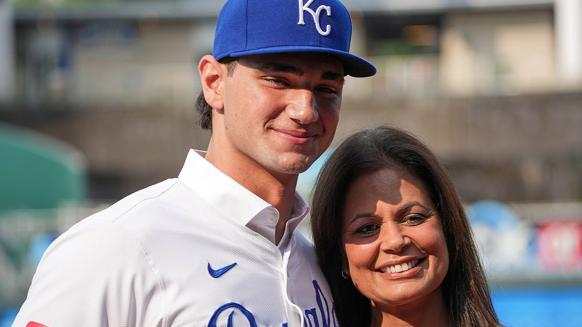 Kansas City Royals first round draft pick Jac Caglianone poses with his mother Johanne Caglianone for photos on the field prior to a game.