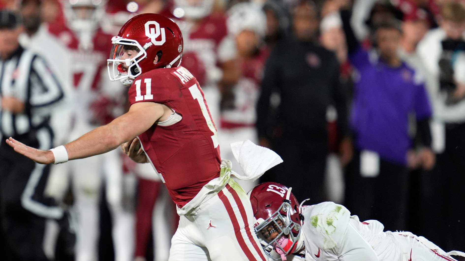 Alabama Crimson Tide defensive back Malachi Moore (13) brings down Oklahoma Sooners quarterback Jackson Arnold (11) during a college football game between the University of Oklahoma Sooners (OU) and the Alabama Crimson Tide at Gaylord Family - Oklahoma Memorial Stadium in Norman, Okla., Saturday, Nov. 23, 2024. Oklahoma won 24-3.