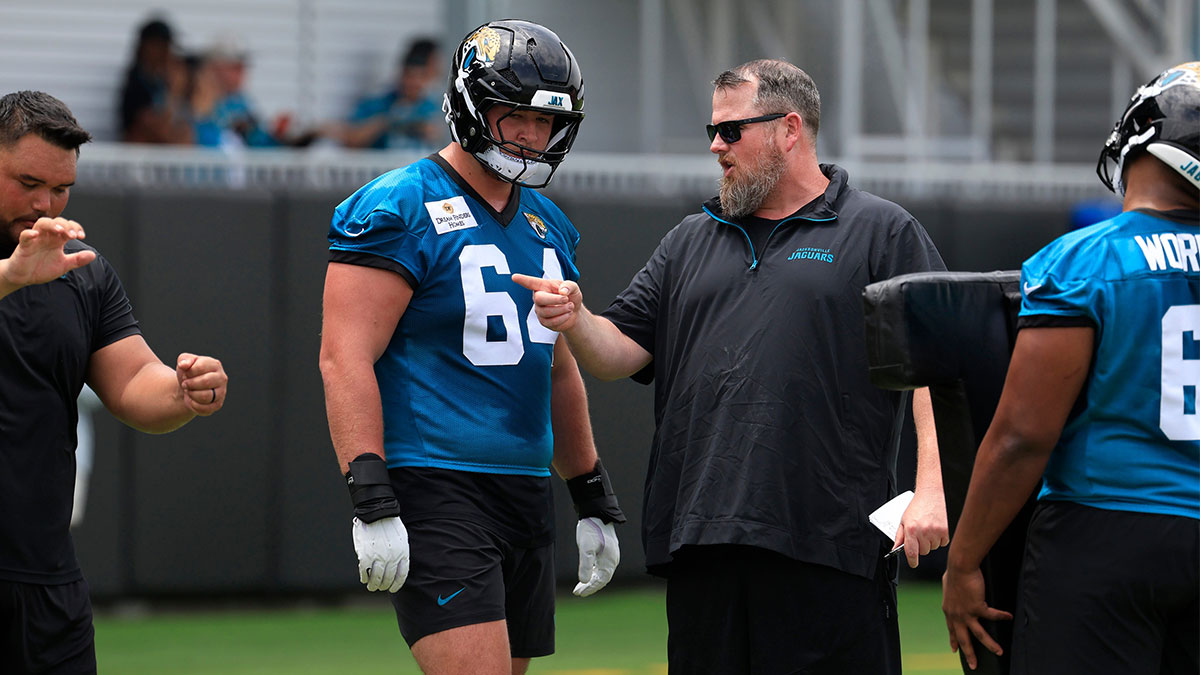 Jacksonville Jaguars guard Wyatt Milum (64) listens to offensive line coach Shaun Sarrett during a rookie minicamp at Miller Electric Center Saturday, May 10, 2025 in Jacksonville, Fla.