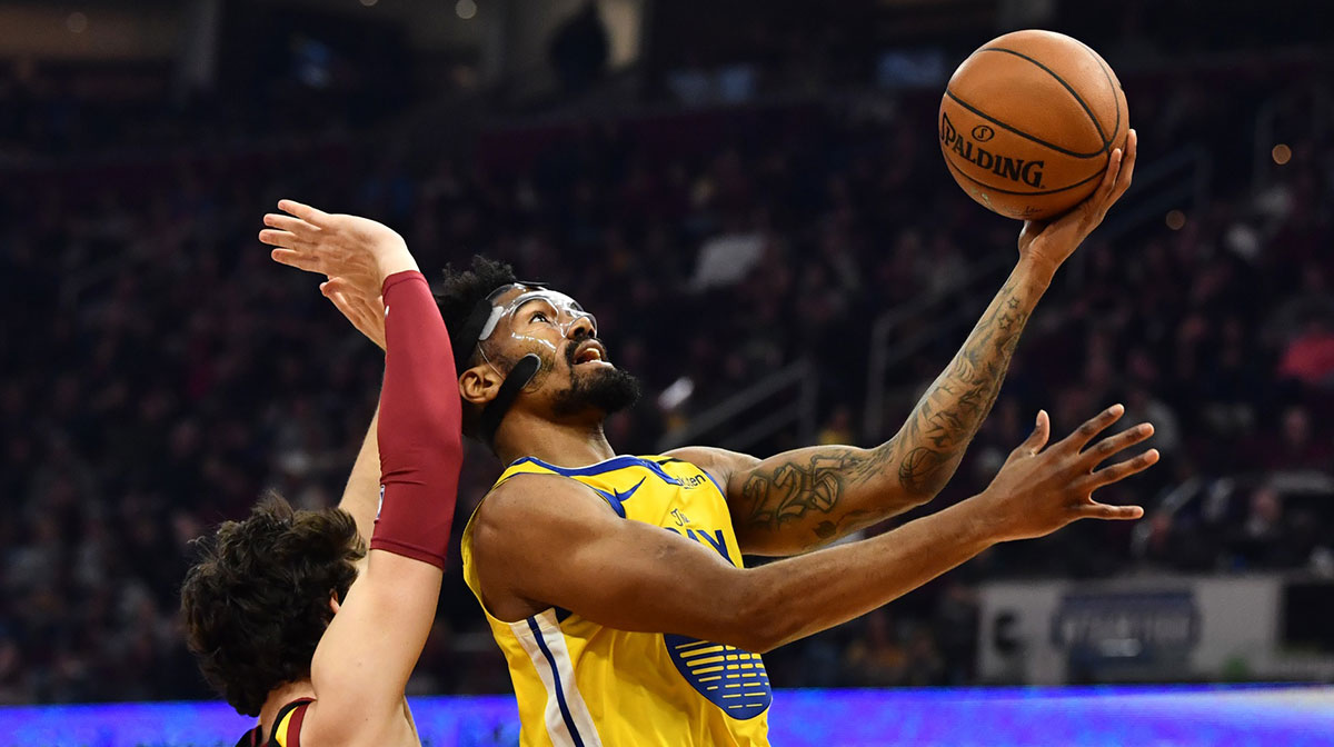 Golden State Warriors guard Jacob Evans (10) drives to the basket against Cleveland Cavaliers forward Cedi Osman (16) during the first half at Rocket Mortgage FieldHouse.