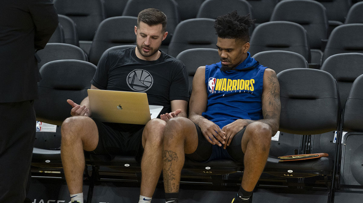 Golden State Warriors guard Jacob Evans (10) looks at video before the game against the Dallas Mavericks at Chase Center.