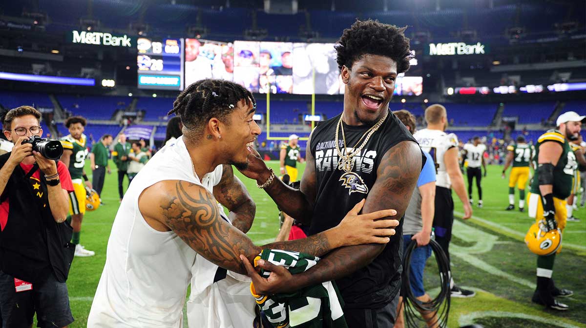Baltimore Ravens quarterback Lamar Jackson (right) talks to Green Bay Packers cornerback Jaire Alexander (left) after the game at M&T Bank Stadium.