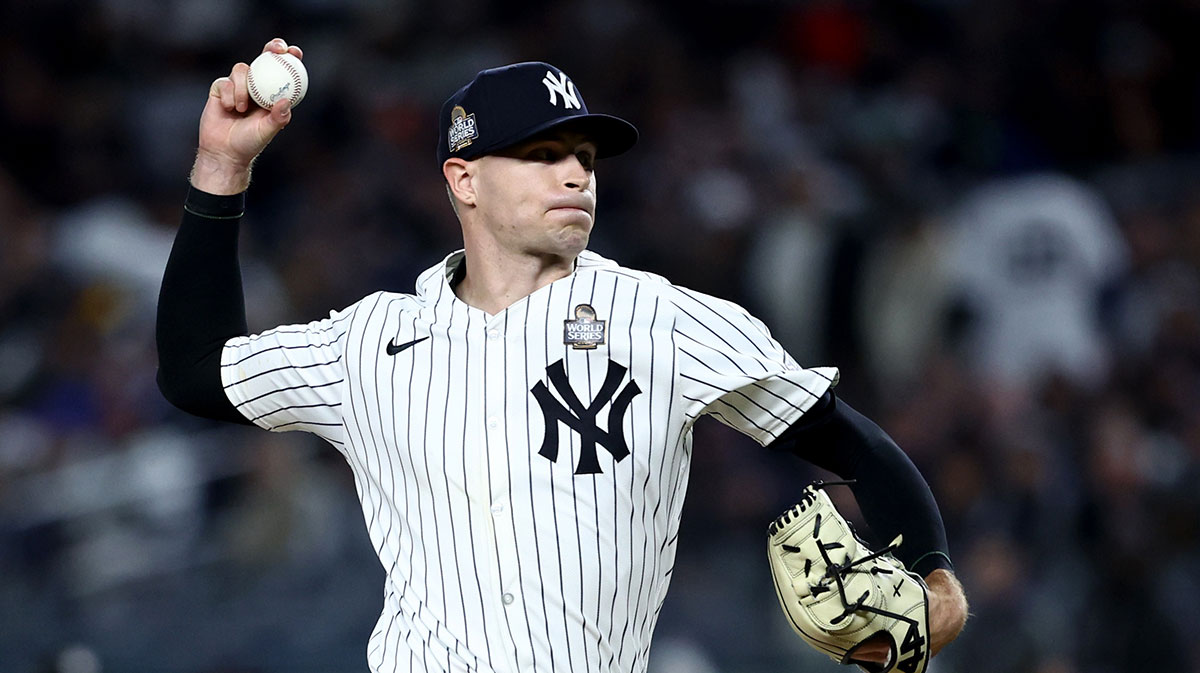 New York Yankees pitcher Jake Cousins (61) throws during the sixth inning against the Los Angeles Dodgers in game three of the 2024 MLB World Series at Yankee Stadium.