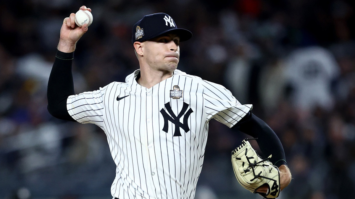 New York Yankees pitcher Jake Cousins (61) throws during the sixth inning against the Los Angeles Dodgers in game three of the 2024 MLB World Series at Yankee Stadium.