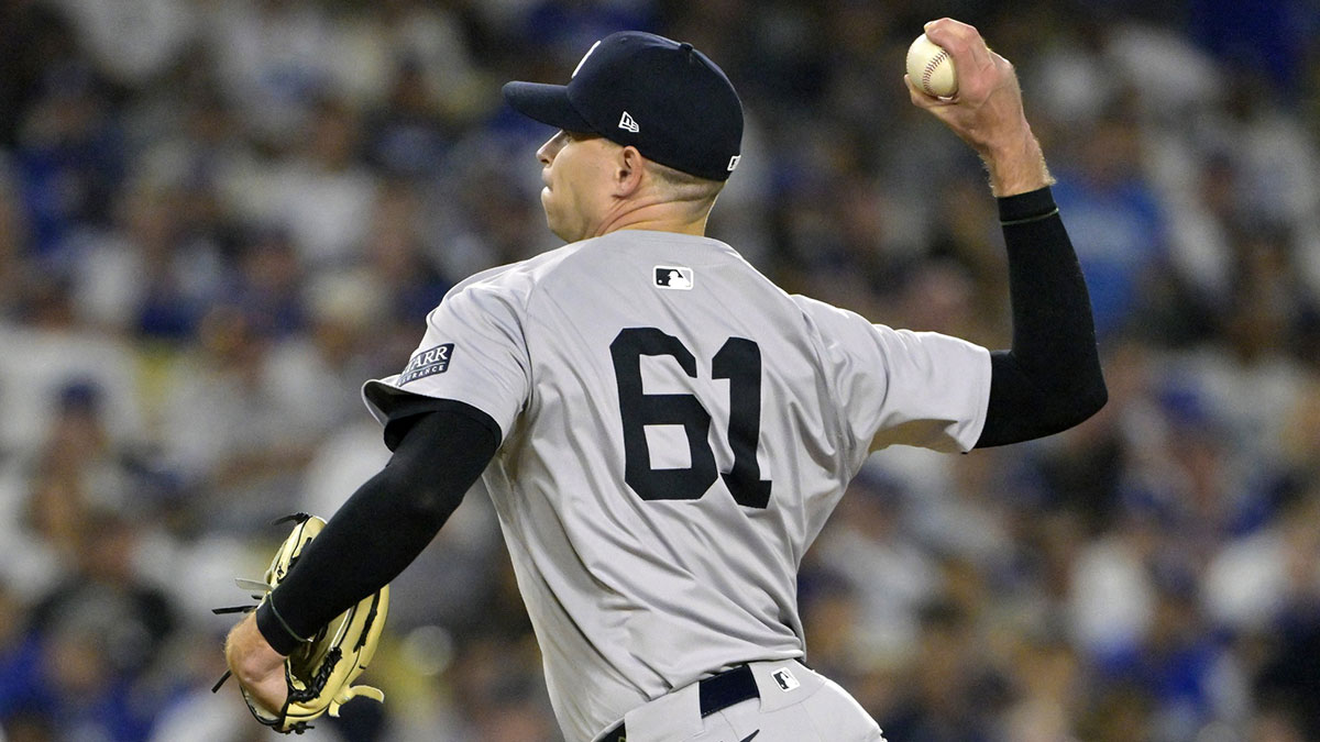 New York Yankees pitcher Jake Cousins (61) pitches in the fourth inning against the Los Angeles Dodgers during game two of the 2024 MLB World Series at Dodger Stadium.