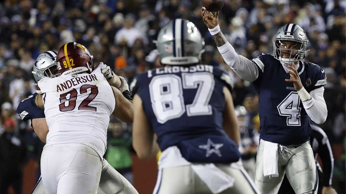 Jan 7, 2024; Landover, Maryland, USA; Dallas Cowboys quarterback Dak Prescott (4) passes the ball to Cowboys tight end Jake Ferguson (87) as Washington Commanders defensive tackle Abdullah Anderson (92) defends during the third quarter at FedExField.