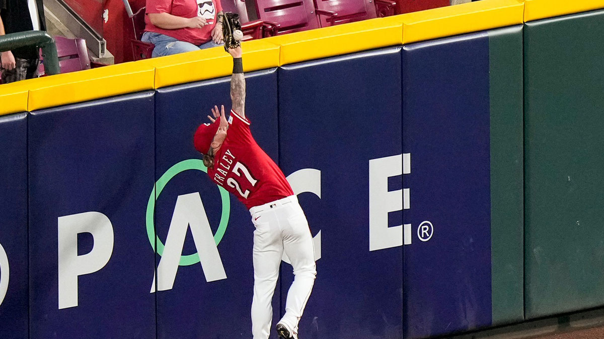 Cincinnati Reds right fielder Jake Fraley (27) leaps but is unable to come down with a three-run home run ball off the bat of Harrison Bader in the sixth inning of the MLB interleague game between the Cincinnati Reds and the Minnesota Twins at Great American Ball Park in downtown Cincinnati on Tuesday, June 17, 2025. The Reds won 6-5.