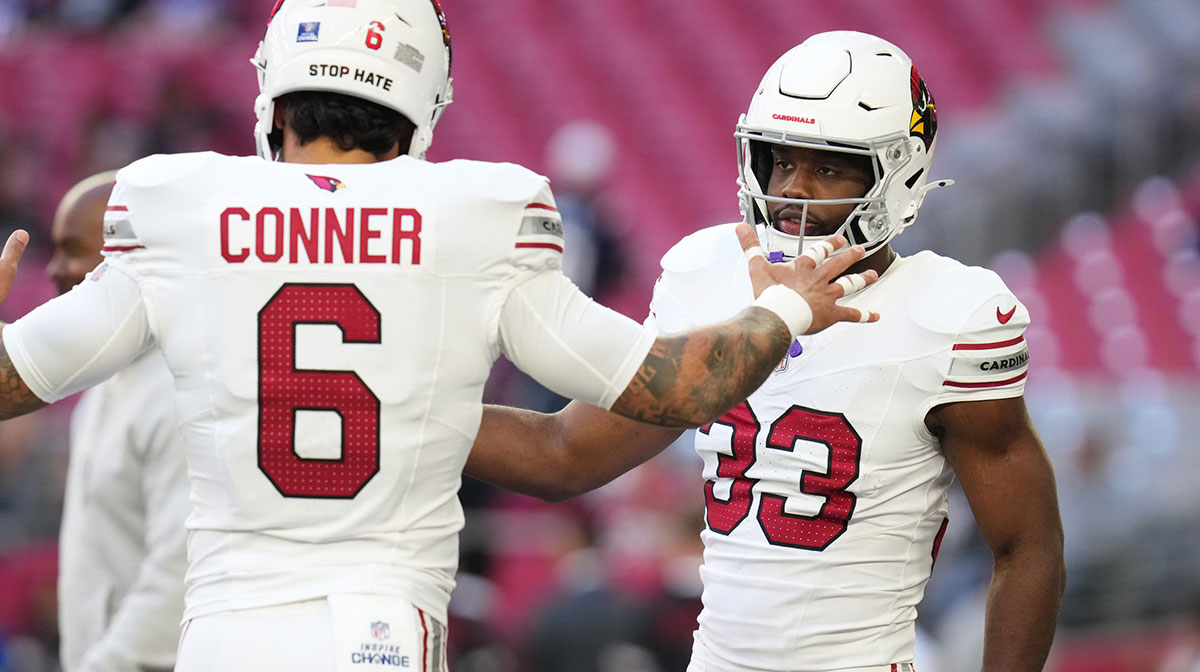 Arizona Cardinals running backs James Conner (6) and Trey Benson (33) high-five before they play against the New England Patriots at State Farm Stadium on Dec. 15, 2024.