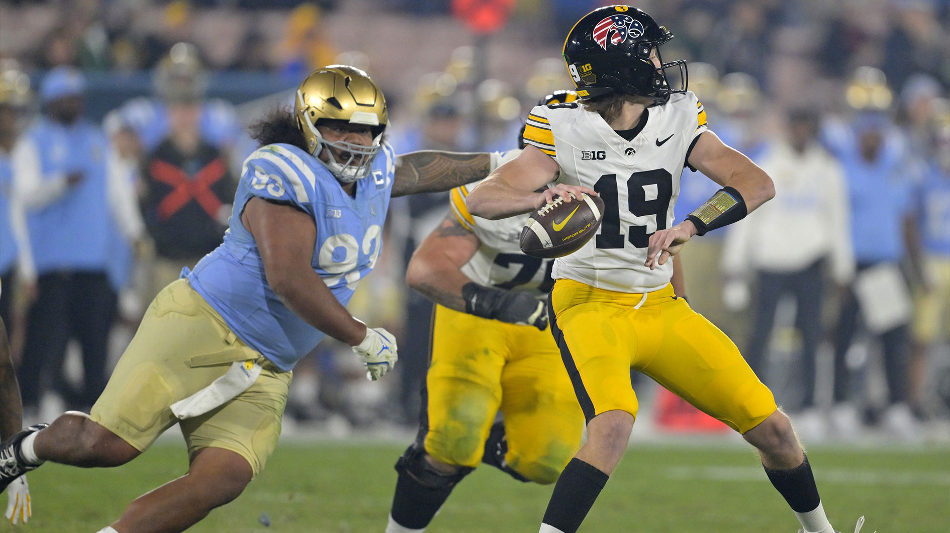 UCLA Bruins defensive lineman Jay Toia (93) pressures Iowa Hawkeyes quarterback Jackson Stratton (19) as he throws a pass in the second half at the Rose Bowl.