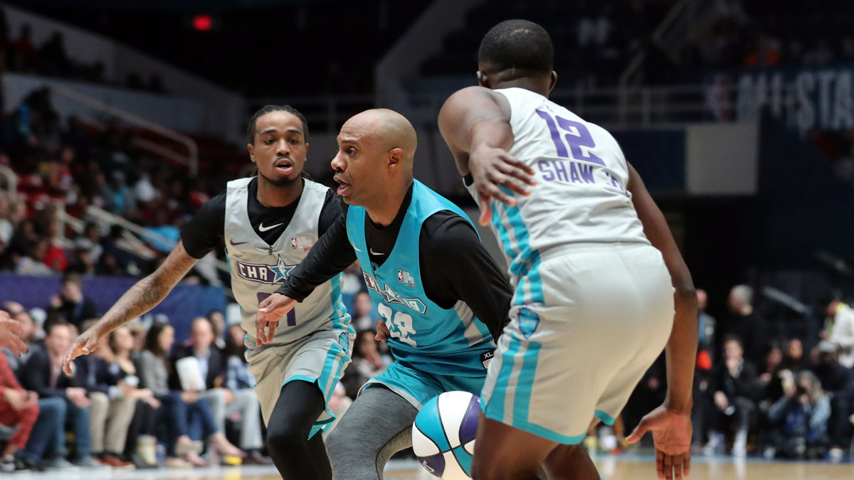 Home Team player Jay Williams is defended by Away Team player James Shaw Jr. during the third quarter at Bojangles Coliseum .