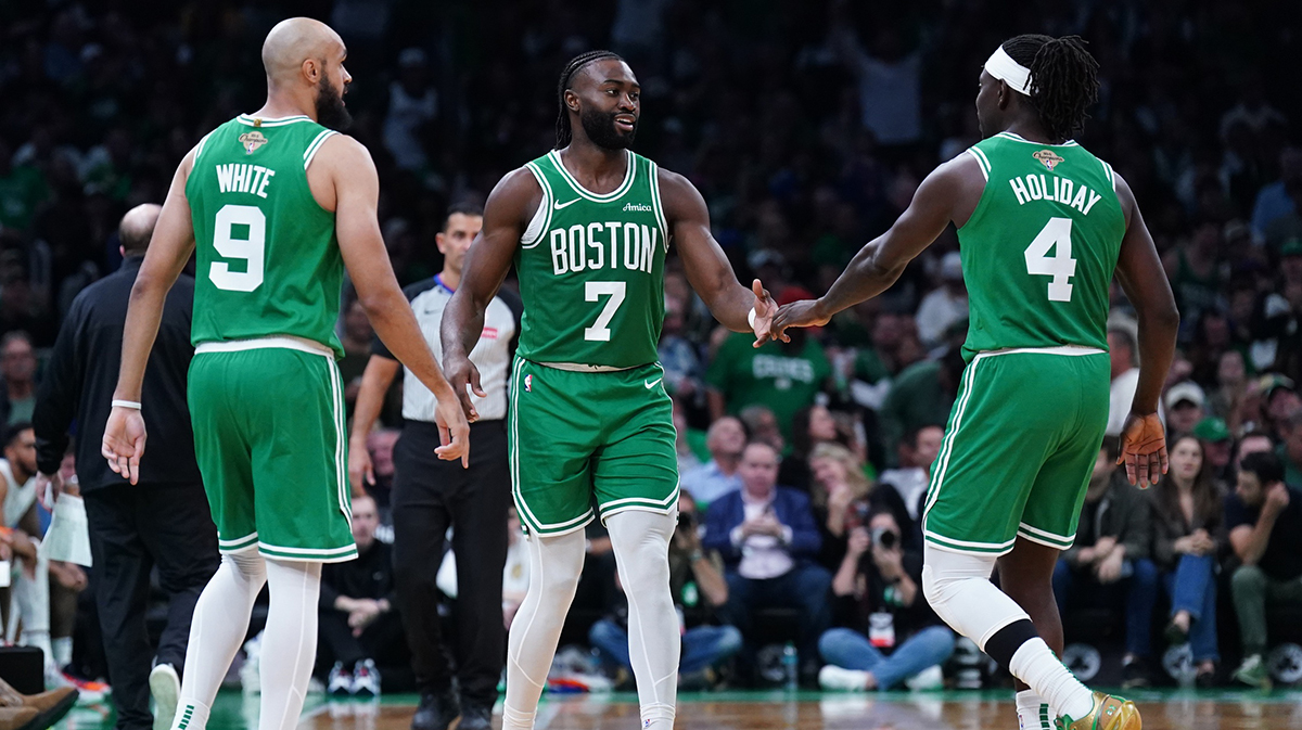 Boston Celtics guard Jaylen Brown (7), guard Jrue Holiday (4) and guard Derrick White (9) react after a play against the New York Knicks in the second half at TD Garden.