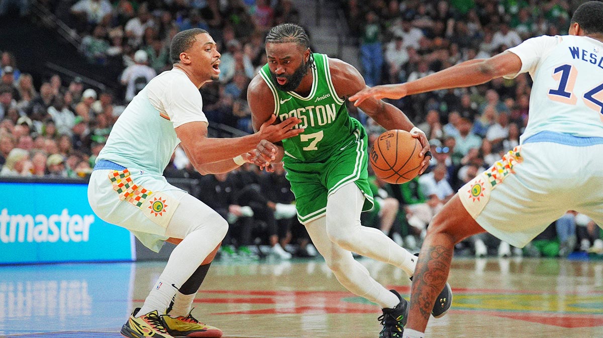 Boston Celtics guard Jaylen Brown (7) dribbles against San Antonio Spurs forward Keldon Johnson (0) in the second half at Frost Bank Center.