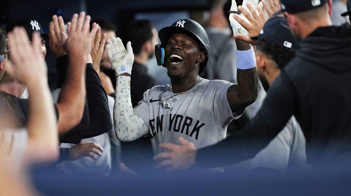 New York Yankees third baseman Jazz Chisholm Jr. (13) celebrates in the dugout after hitting a two-run home run against the Toronto Blue Jays during the fourth inning.