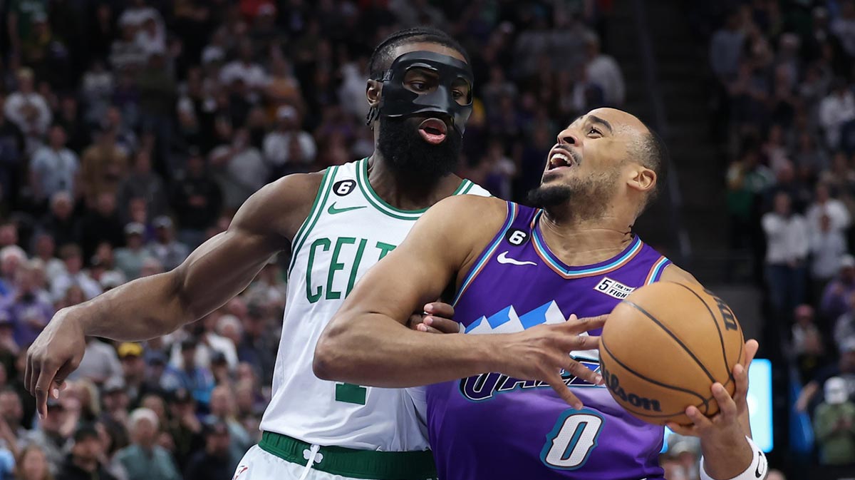 Utah Jazz guard Talen Horton-Tucker (0) drives the ball against Boston Celtics guard Jaylen Brown (7) in the last minute of the game at Vivint Arena.