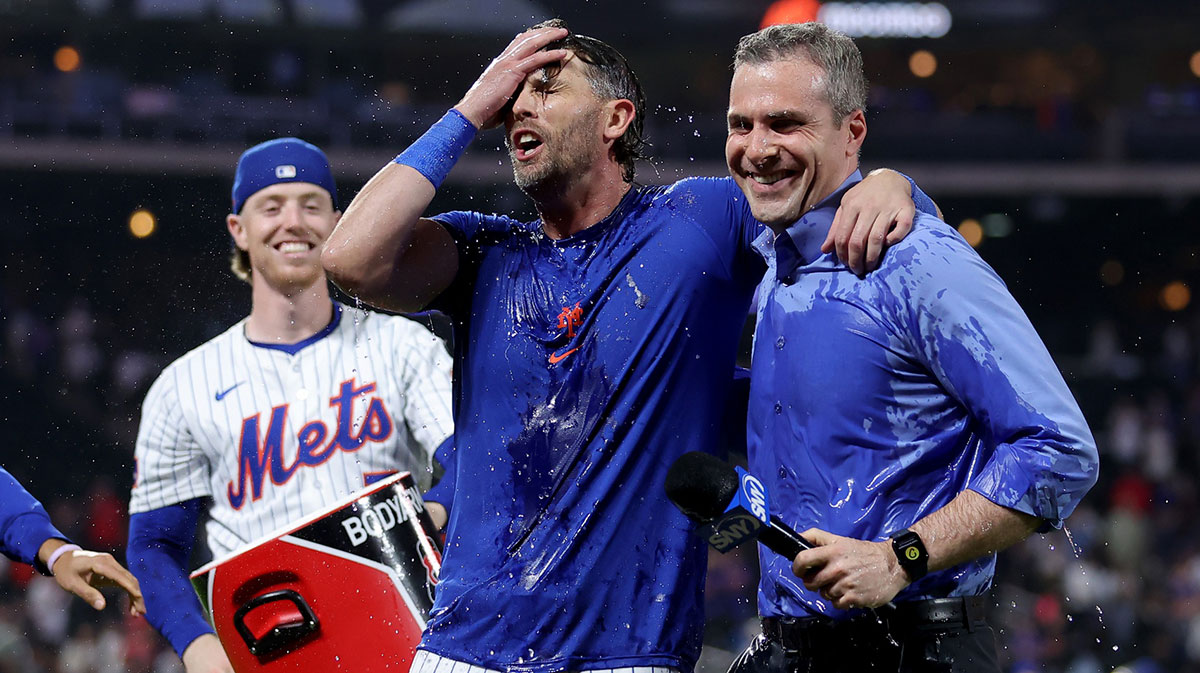New York Mets second baseman Jeff McNeil (1) and field reporter Steve Gelbs reacts after being doused by third baseman Brett Baty (7) after McNeil's game winning hit against the Washington Nationals in the tenth inning at Citi Field.