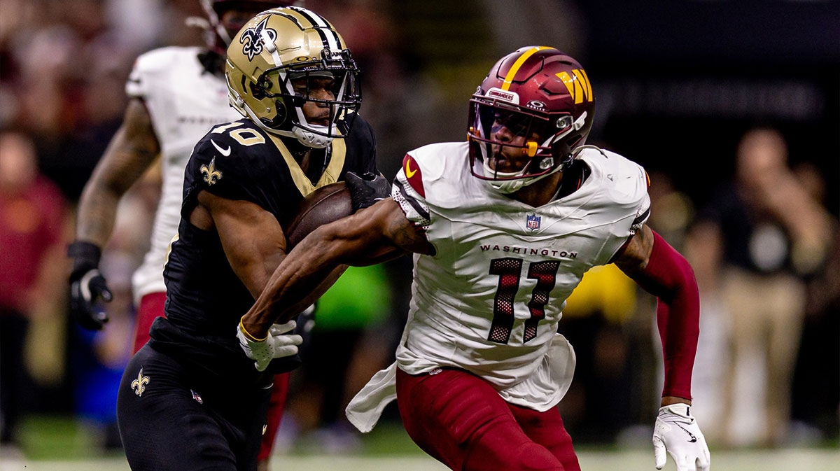 Washington Commanders safety Jeremy Chinn (11) tackles New Orleans Saints wide receiver Marquez Valdes-Scantling (10) during the second half at Caesars Superdome.