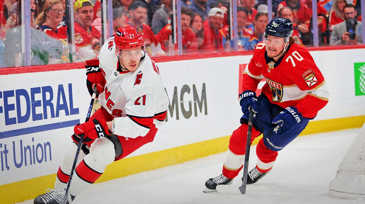 Carolina Hurricanes defenseman Alexander Nikishin (21) controls the puck as Florida Panthers center Jesper Boqvist (70) defends during the second period in game four of the Eastern Conference Final of the 2025 Stanley Cup Playoffs at Amerant Bank Arena.