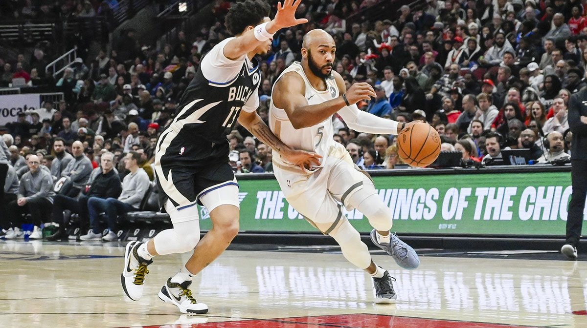Chicago Bulls guard Jevon Carter (5) moves the ball against Milwaukee Bucks guard Ryan Rollins (13) during the first half at the United Center.