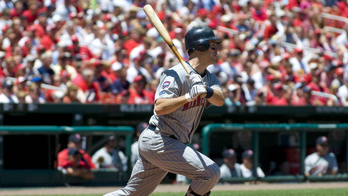 Minnesota Twins catcher Joe Mauer (7) follows through on a single off against the St. Louis Cardinals in the first inning at Busch Stadium. Minnesota defeated St. Louis 6-2.