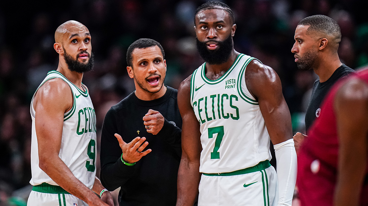 Boston Celtics head coach Joe Mazzulla talks with guard Jaylen Brown (7) and guard Derrick White (9) from the sideline as they take on the Cleveland Cavaliers at TD Garden.