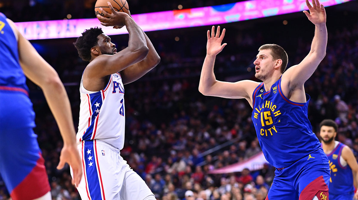 Philadelphia 76ers center Joel Embiid (21) shoots the ball against Denver Nuggets center Nikola Jokic (15) in the third quarter at Wells Fargo Center.