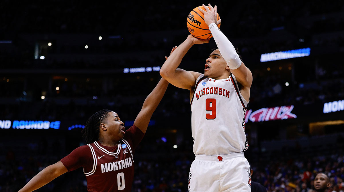 Wisconsin Badgers guard John Tonje (9) shoots the ball against Montana Grizzlies guard Money Williams (0) during the first half in the first round of the NCAA Tournament at Ball Arena.
